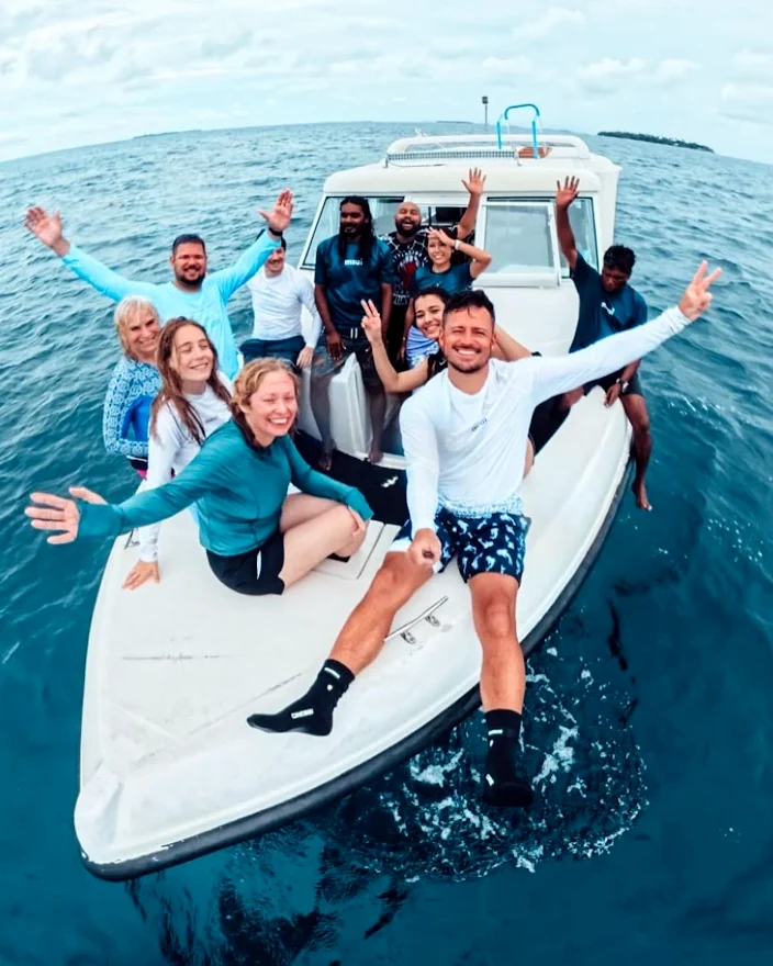 Group of customers on a boat at sea wearing custom long-sleeve rashguards made by Sportswear of Tomorrow