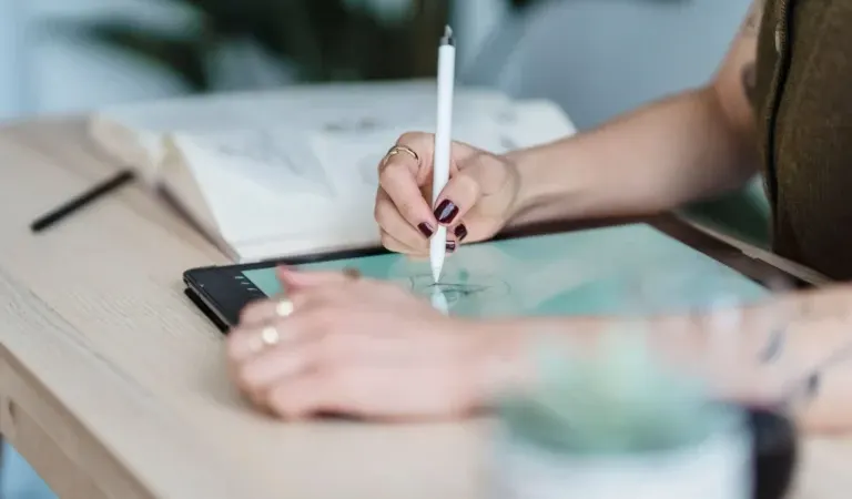 Designer sketching a garment on a tablet with a stylus, AI sportswear design workflow